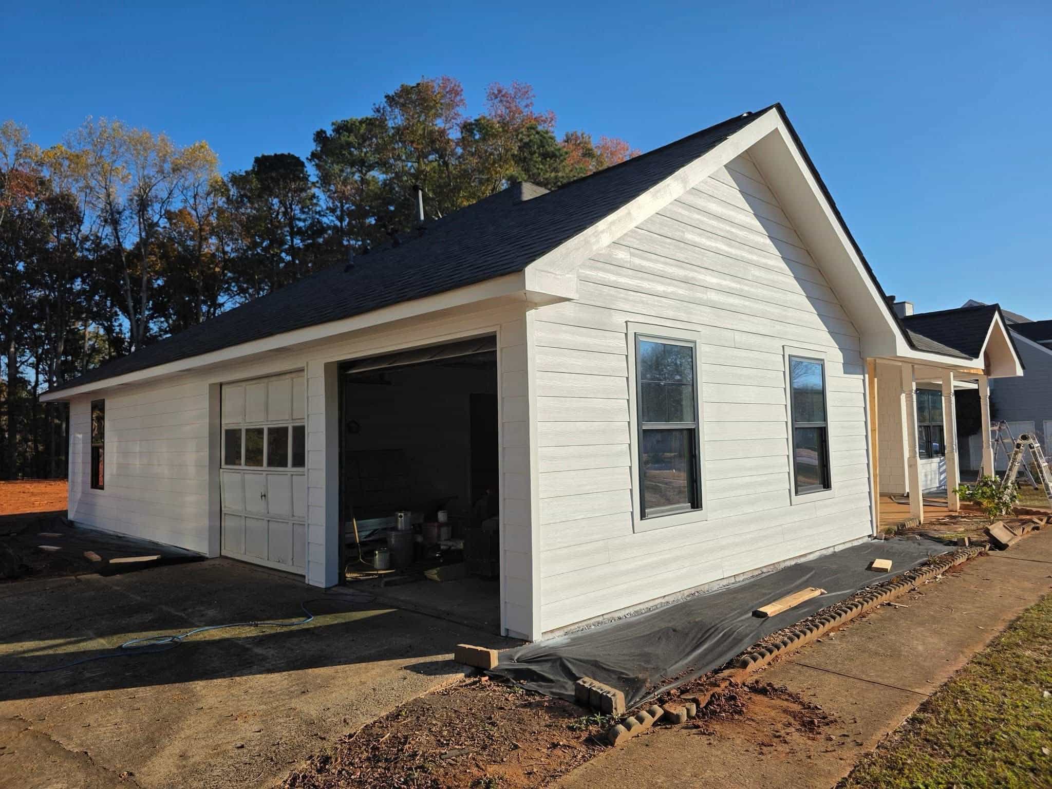 Black gutter and downspout detail on new construction siding