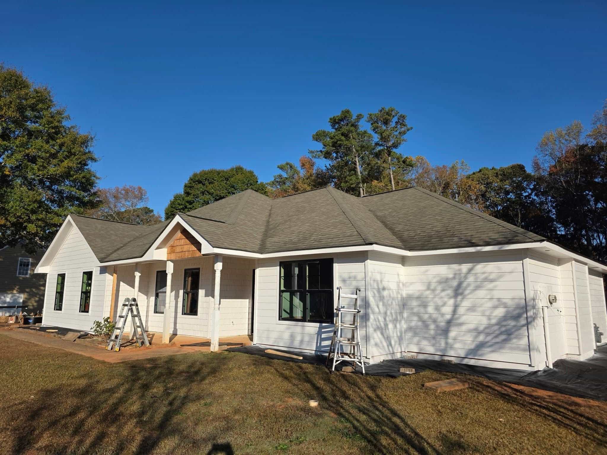 New construction rear view with black seamless gutter system installed