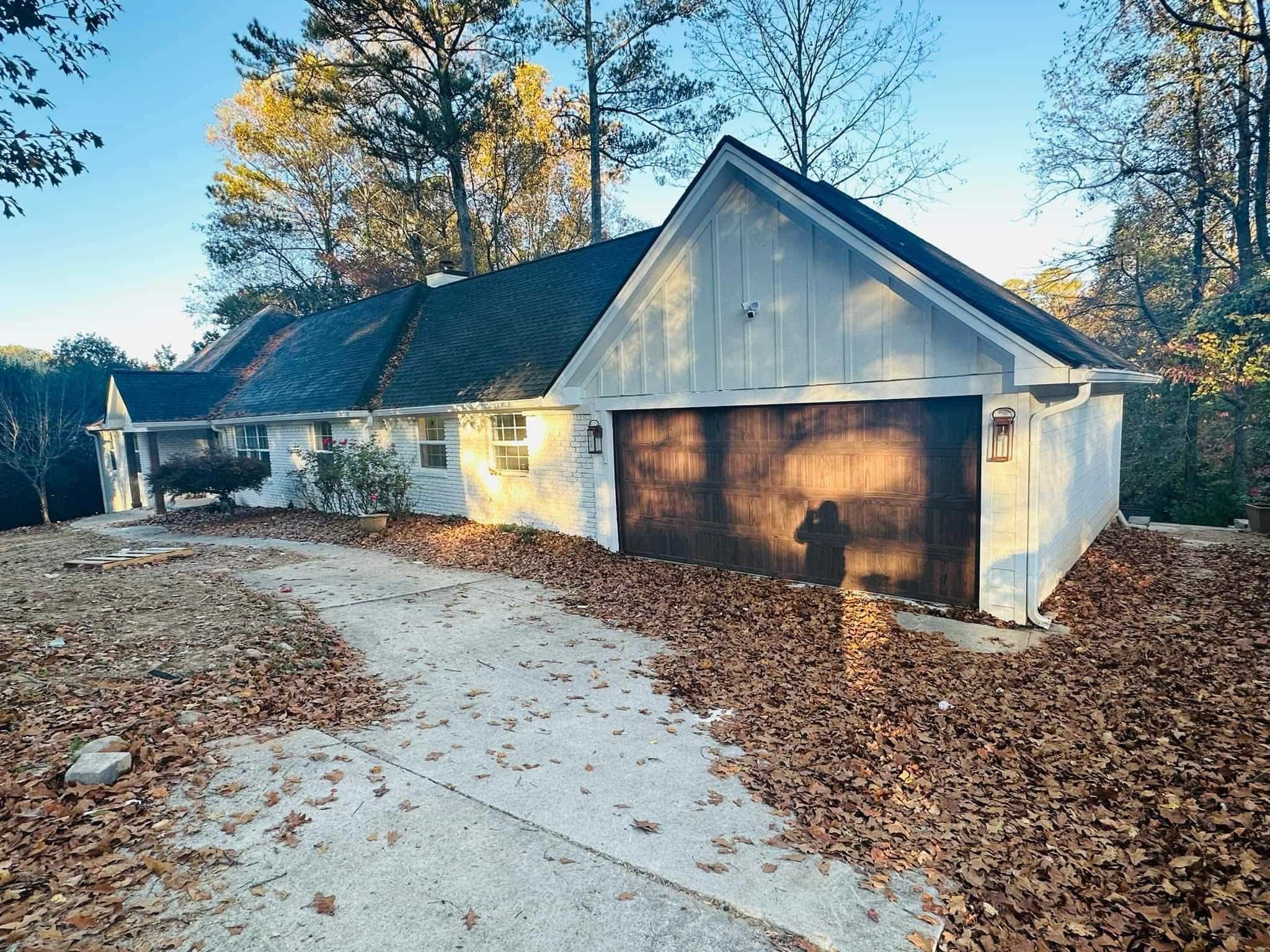 White brick ranch front elevation with garage and new gutter system