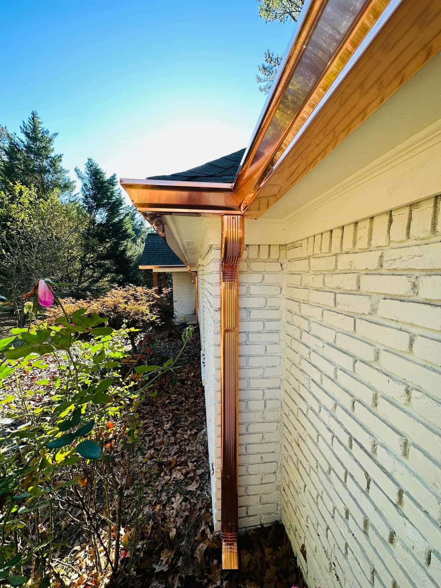 Copper gutter system detail — corrugated round downspout and half-round trough