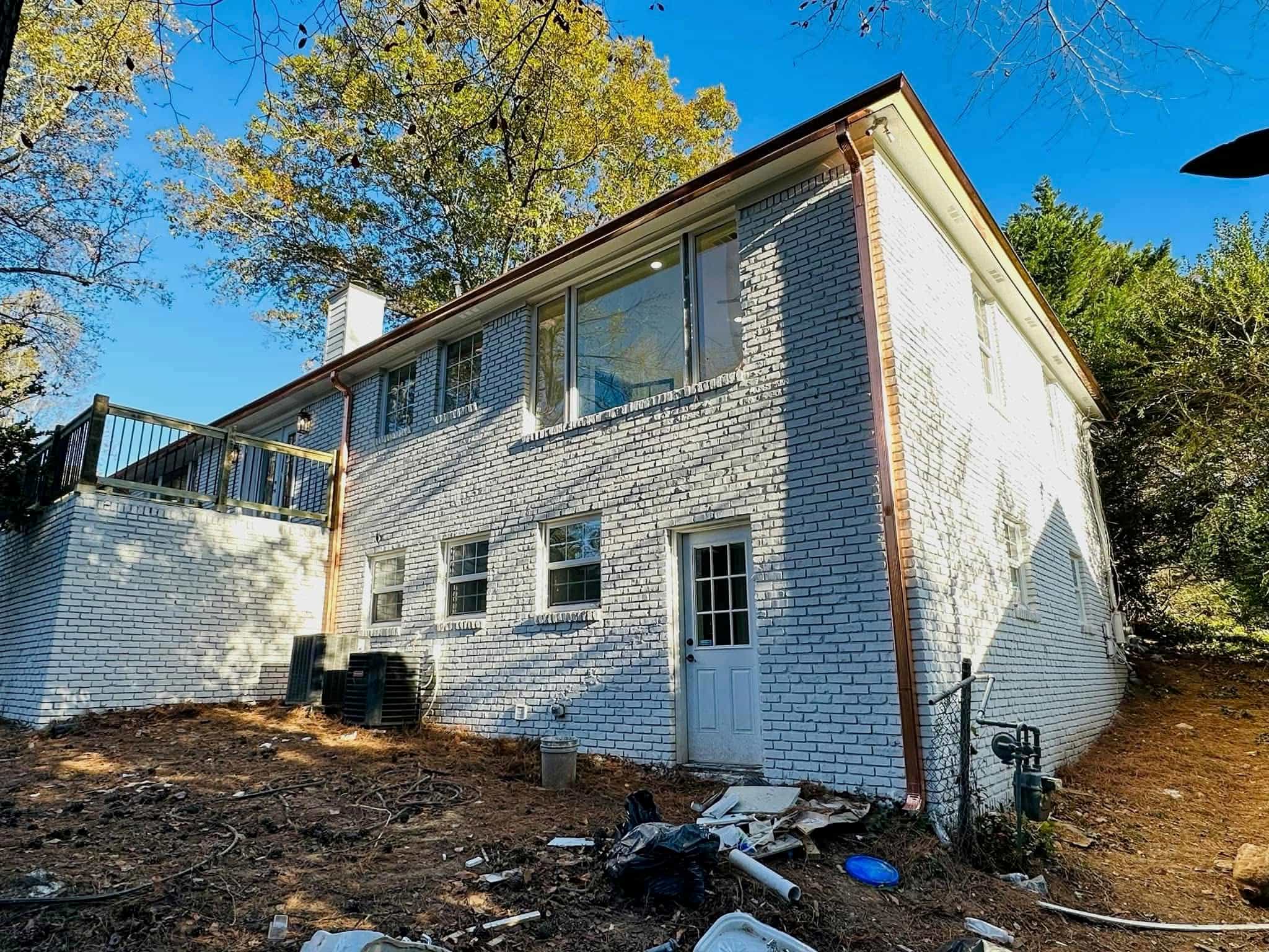 Two-story home rear view with full copper gutter and downspout system