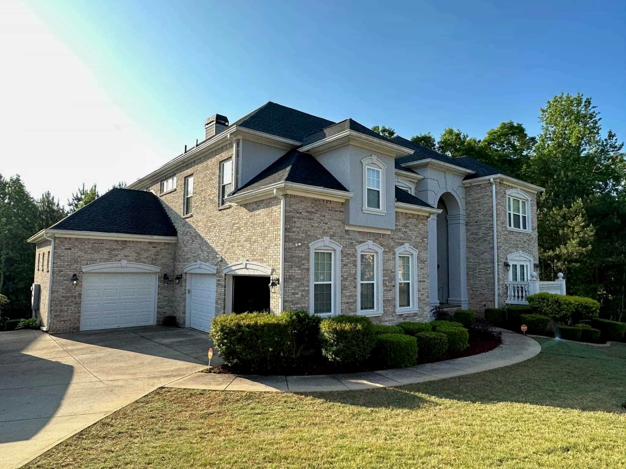 Luxury brick estate front elevation — complete with balcony and arched entry