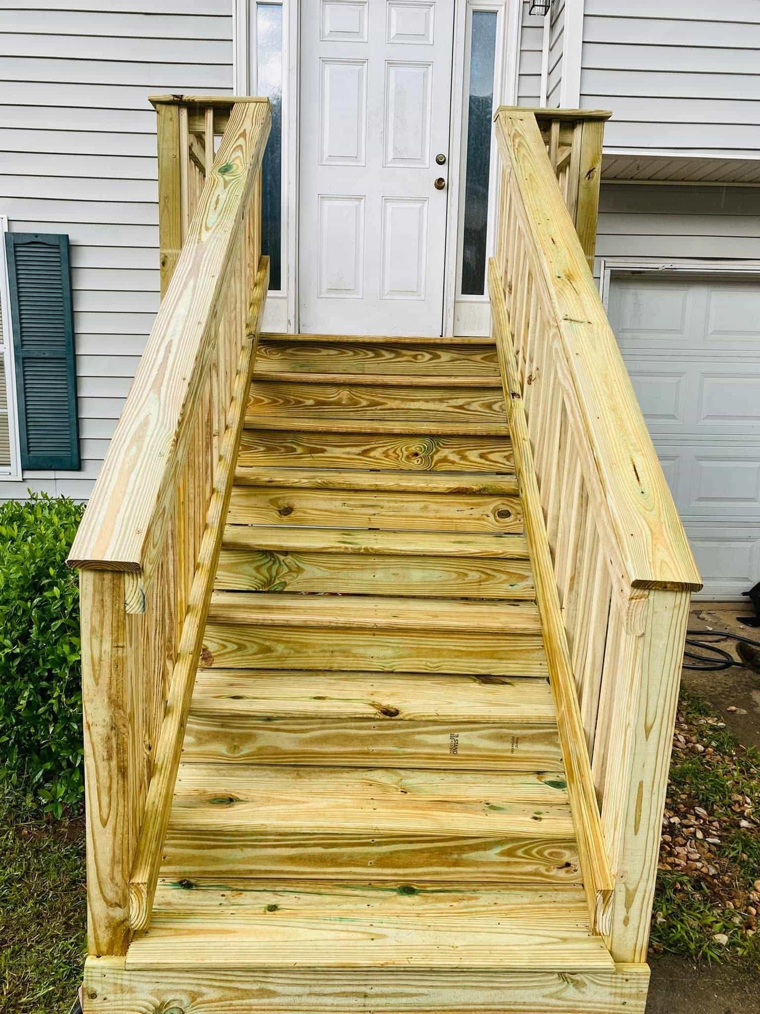 After — brand new pressure-treated wood stairs with solid treads and railings
