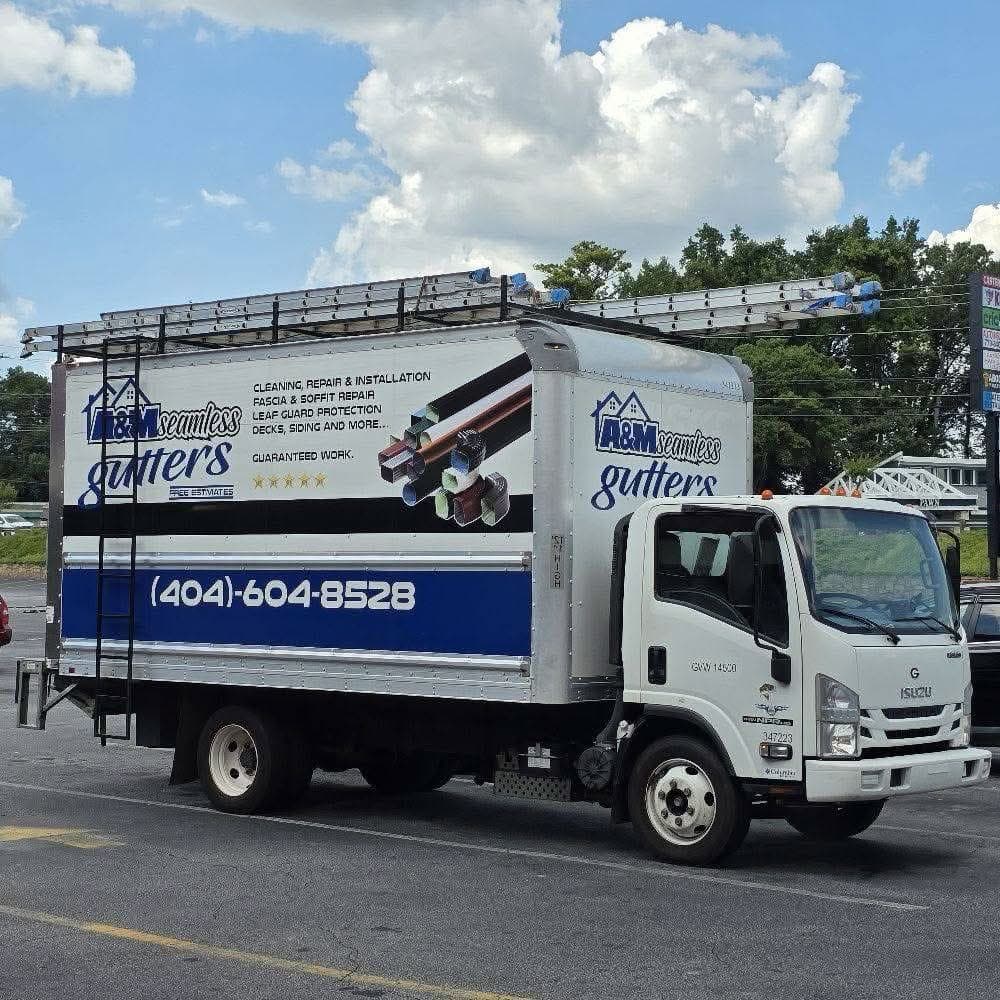 A&M Seamless Gutters branded Isuzu work truck with company wrap — (404) 604-8528